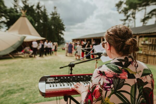 Summer Festival Tipi wedding - live music, live singer on keyboard, playing to tipi wedding guests