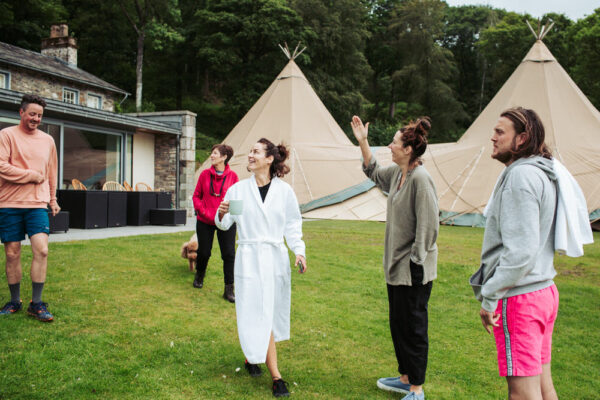 Bridal party in front of tipi tent at Silverholme Manor, Graythwaite Estate, Cumbria