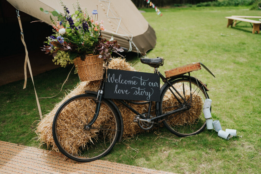 Decorative bike with floral display in front of Tipis - Wedding decorations - Wedding styling ideas - Tipi styling - Outdoor wedding Cumbria