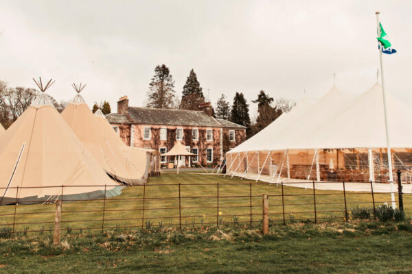 Sperry tent - Sailcloth marquee next to Giant Hat Tipis - teepee and marquee - outdoor wedding Cumbria