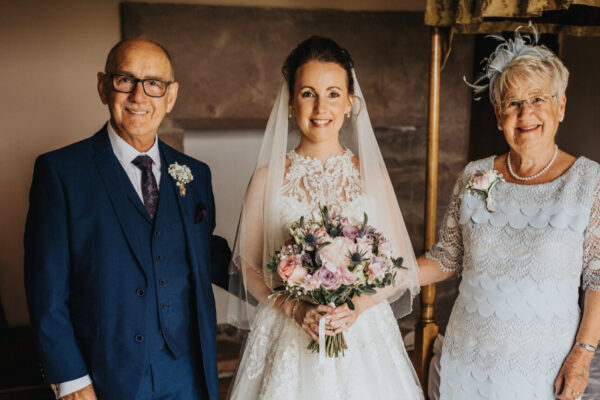 Bride and her parents - wedding dress -- mother of the bride - father of the bride