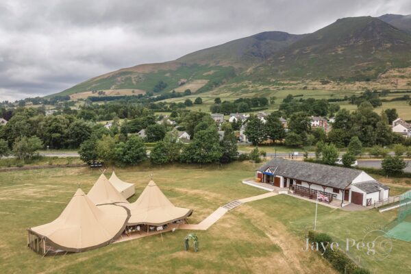 Beautiful Tipi Tents with the Lake District Mountains behind at Lake District Wedding Venue Threlkeld Cricket Club in Cumbria