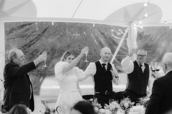 Cheers! Toasting Time - Wedding Speech Time on the Top Table - Wedding Party top table beautiful views from Sailcloth Marquee Tent